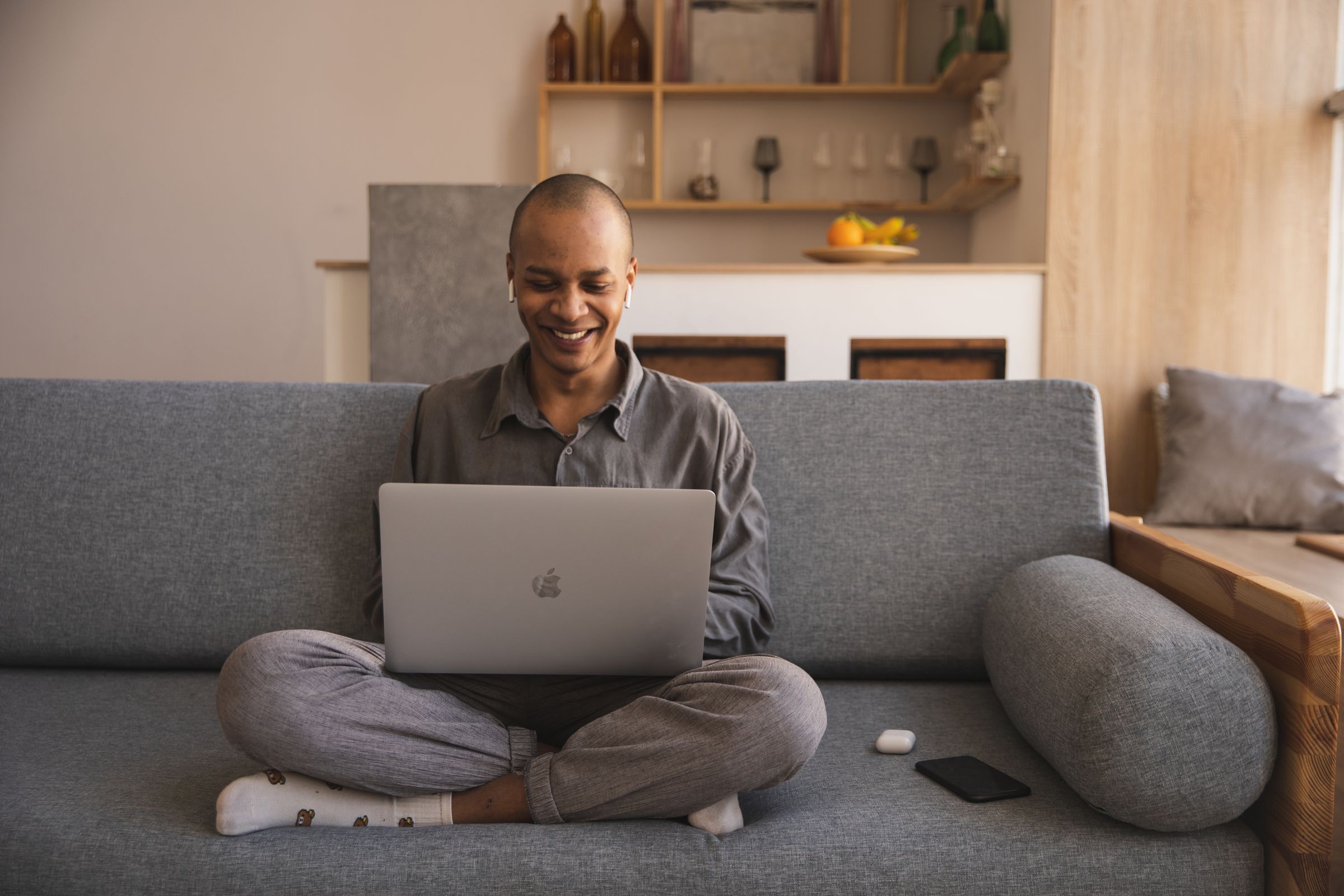 A man smiling while reviewing his health data on a laptop