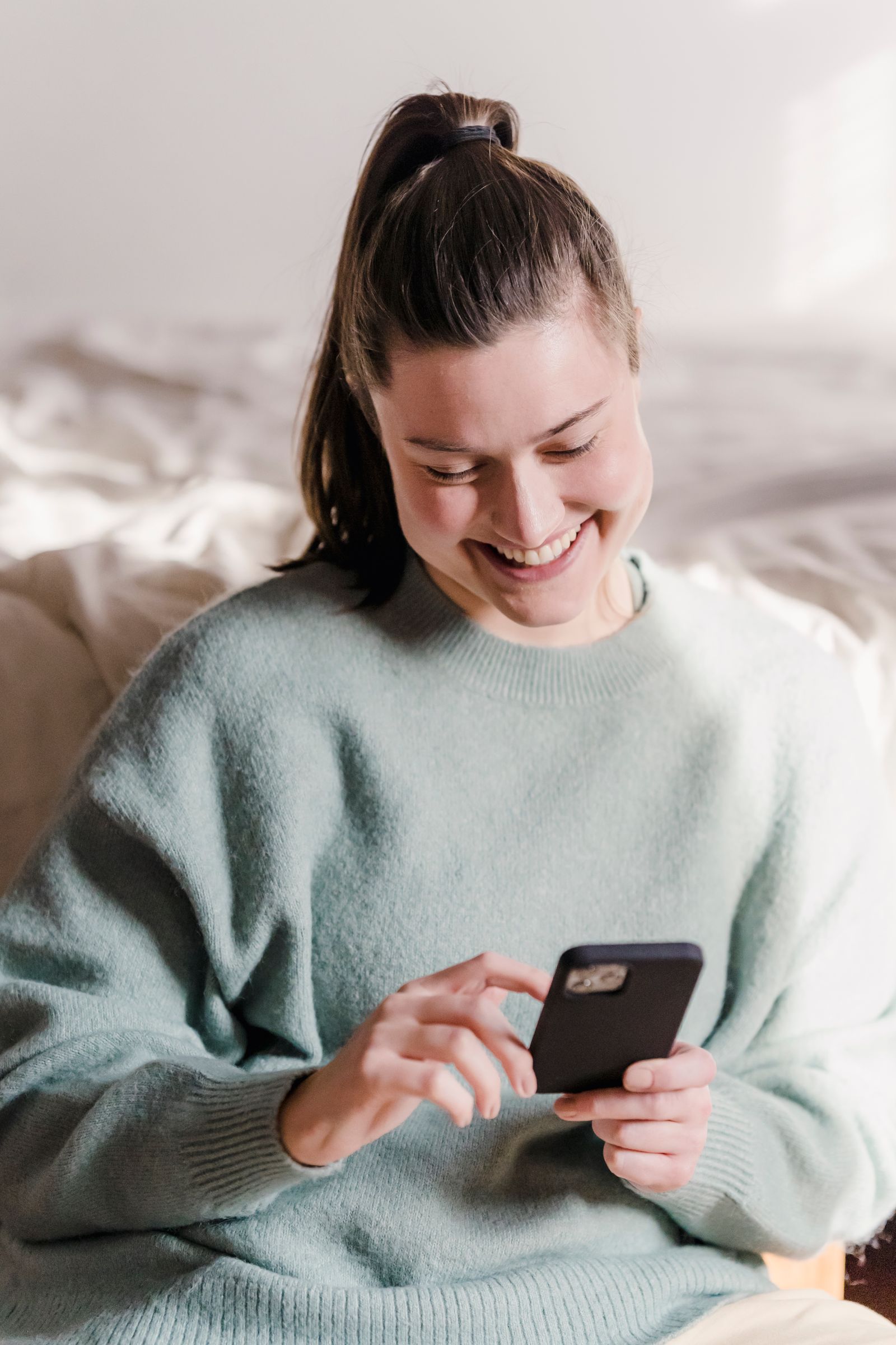 A woman smiling at a screen showing her medical record